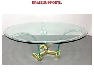 Lot 1016 Modernist Designer Glass Cocktail Coffee Table. Tree Flared Glass Legs with Heavy Brass Supports.
