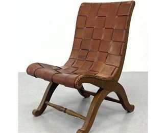 Lot 1133 Spanish Woven Leather Strap Lounge Chair. Wood Frame with metal stud trim. 