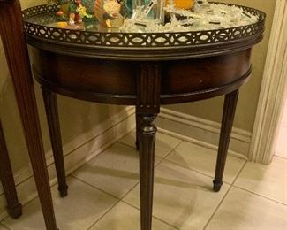 mirror top round table with a galley rail band. so nice