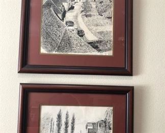 a couple of framed drawings