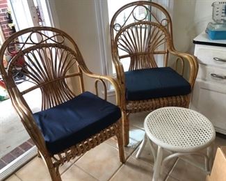 A pair of rattan chairs and a rattan stool