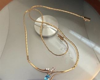 14K gold necklace w/ blue topaz and tiny diamonds. 