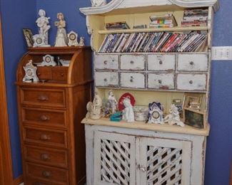 Tall standing roll-top cabinet and a primitive cabinet