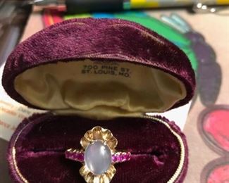 Deco era engagement ring with oval moonstone & 6 rubies in a 10k ruffled setting. Size 6 1/4 - Comes with the original burgundy velvet box. 