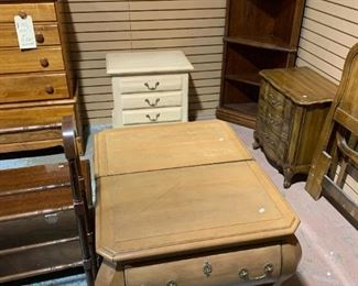2 bombay-styled wood bedside tables. Off white wood bedside table, to the right is Thomasville french provincial double headboard, mirror and bed side table.