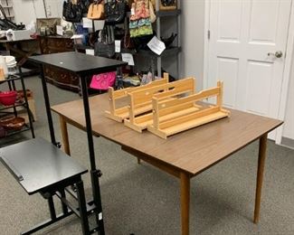 Standing desk is sold. MCM formica top kitchen table. Large assortment of handbags, sorted by designer, woven, leather, novelty, evening, wallets & accessories, other.