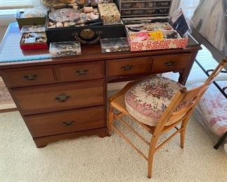 Compact desk; sewing and needlework supplies/accessories.