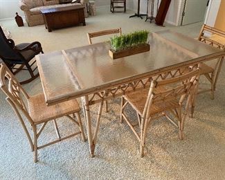 Vintage glass-top rattan sunroom/dining table with four chairs.