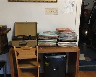 Vinyl record albums. Record player. Paper shredder.