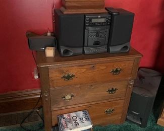 . . . three drawer dresser with mantle clock and stereo system