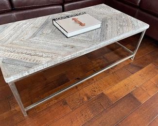 Cocktail/coffee table with brushed chrome legs with a distressed wood top, and we have some nice "coffee table books:)