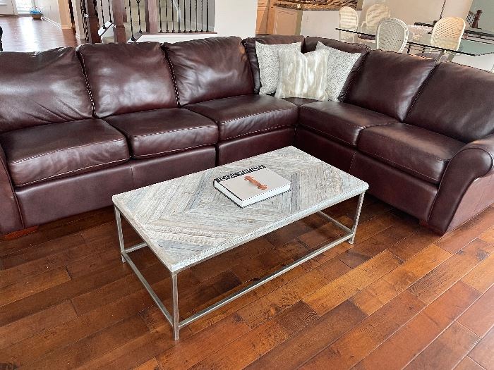 Leather sectional - excellent condition - shown with faux fur and upholstered throw pillows (also available) and a wood and chrome cocktail table