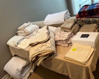 Table and bed linens for sale during in-person shopping Friday and Saturday.