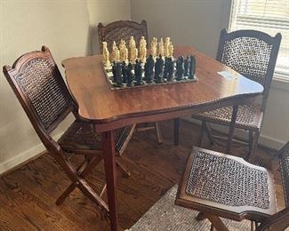 $60 Game table and four chairs. Everything folds flat for storage. 29.25 inches high by 31.5 in.².