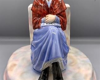 This is a Unique Porcelain Grandmother Sitting on a Chair with Round Base by Will-George Pottery Co.  William Shaw George purchased the controlling interest in the East Palestine Pottery Company from the Sebring brothers in 1904, renaming the company The W. S. George Pottery Company. In 1910 the company opened a manufacturing facility in Canonsburg, Pennsylvania 