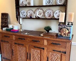 This dining set was purchased in the early 1950s by our homeowner's in-laws. It was hand carved in Brittany, France by master carpenters. Truly unique and a show-stopper! The seats are woven in leather!   (plate rack not available)