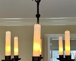 Hand forged Chandelier, made and purchased in France 1950's with glass shades on the bulbs