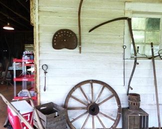 Scythes, iron tractor seat, mule drawn plow, crates, wagon wheel