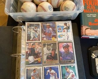 Game day played baseballs with MLB hologram authentication stickers & binder filled with 200+ baseball cards.