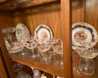 Fine crystal coupe champagne glasses & antique Royal Vienna cabinet plates.