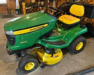 John Deere X300 riding mower with bagger. 223.3 hours