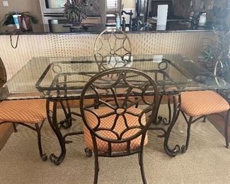 glass to and iron base table and chairs