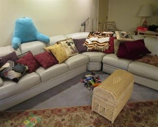 L shaped leather mid century sofa, lots of pillows