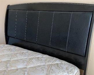 queen size black leather and wood bed