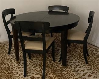 Pottery Barn Ebony Extension Table on Casters. Shown with Set of 4 Pottery Barn Dining Chairs.  Table Measures 47" D and Extends to 84" L x 47" W x 29" H with Two 18" Leaves. Photo 1 of 2. 