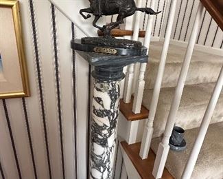 One of many plantstand pillars throughout the sale with the Frederic Remington bronze statue on top