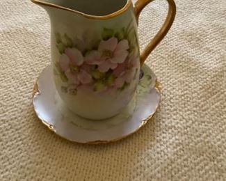 Small pitcher with matching saucer