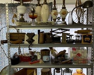 MCM lamps, oil lamps, Pearl Beer glasses, lanterns, general store grinder, wooden cheese box, Victorian sad irons, enamel potty, wood ammo crate, telephone batteries, postal scale, Jax beer tray, school globe, barbed wire, antique bottles, plastic Christmas decor from the early 60s . . . keep looking!