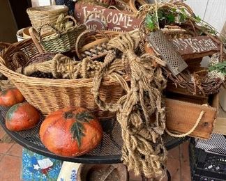 Baskets galore! Plus macramé plant hangers, grapevine wreaths, wooden crates, old milk can. Pumpkins are painted rocks.
