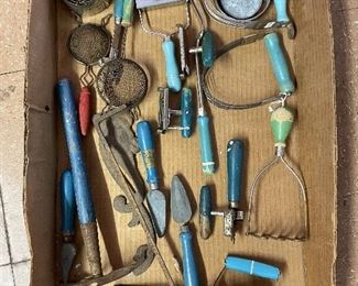Old kitchen utensils. Mostly blue, some green, some red.