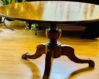 Antique round pedestal table with brass feet