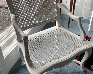 White painted caned arm chair.