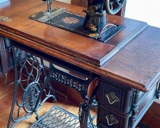 Beautiful, antique Singer sewing machine in original stand.