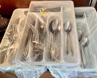 Several sets of stainless flatware