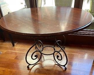 Solid cherry top on iron base. Top is in need of refinishing. This is a quality piece worthy of refinishing.