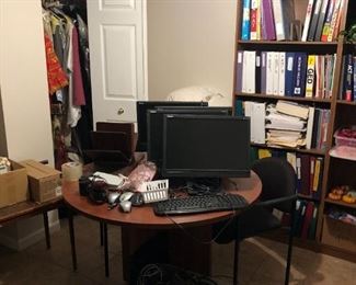 COMPUTER SCREENS AND BOOKS AND SHELVING