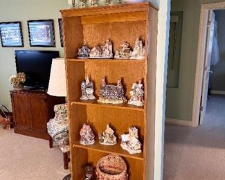 Bookcase with collectible David Winter cottage figures.