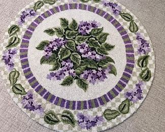 Pretty round lilac hooked rug.