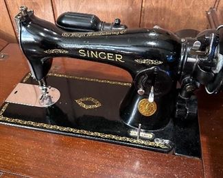 Singer sewing machine in cabinet.