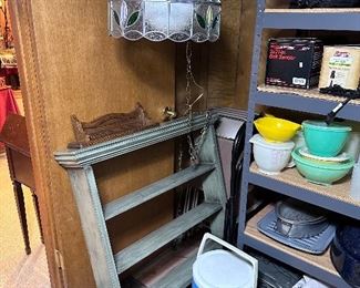 Wall display shelving unit & leaded hanging light fixture.