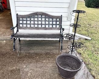 Garden bench, wrought iron plant stand and hose pot.