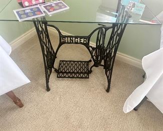 Antique Singer sewing machine base with glass top table.