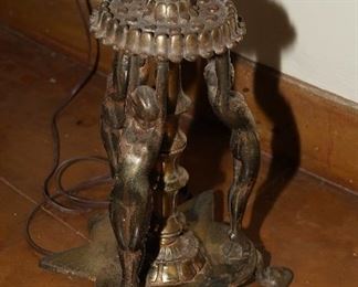 Ladies with outstretched arms holding up the lamp at the base