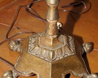 Feet on the antique brass floor lamp