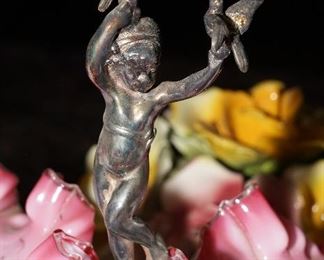 Cherubs holding birds, one on each side