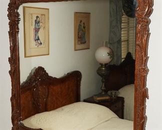 Heavily carved wood framed wall mirror